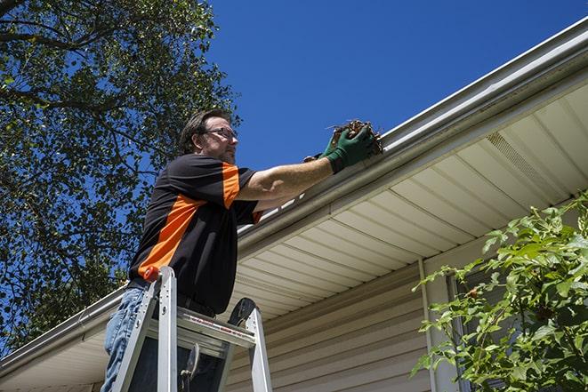 maintenance worker replacing a damaged gutter in Branchburg NJ